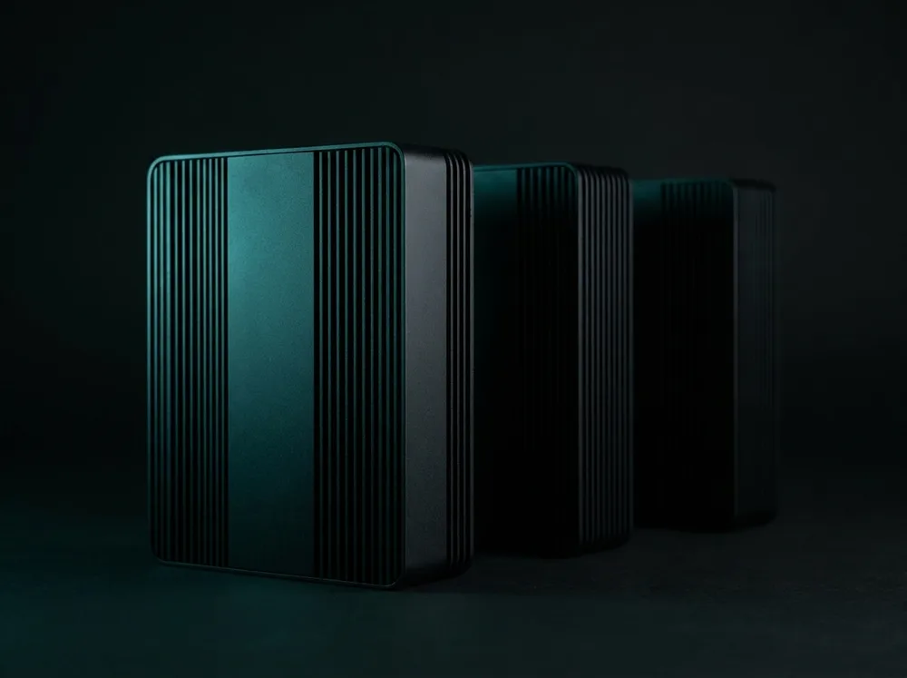 A row of matte-black business mini-PCs